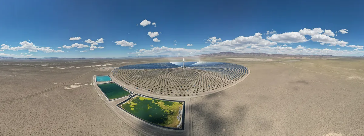 Aerial view of the Crescent Dunes solar field: thousands of mirrors arranged in rings around a central tower in the Nevada desert.