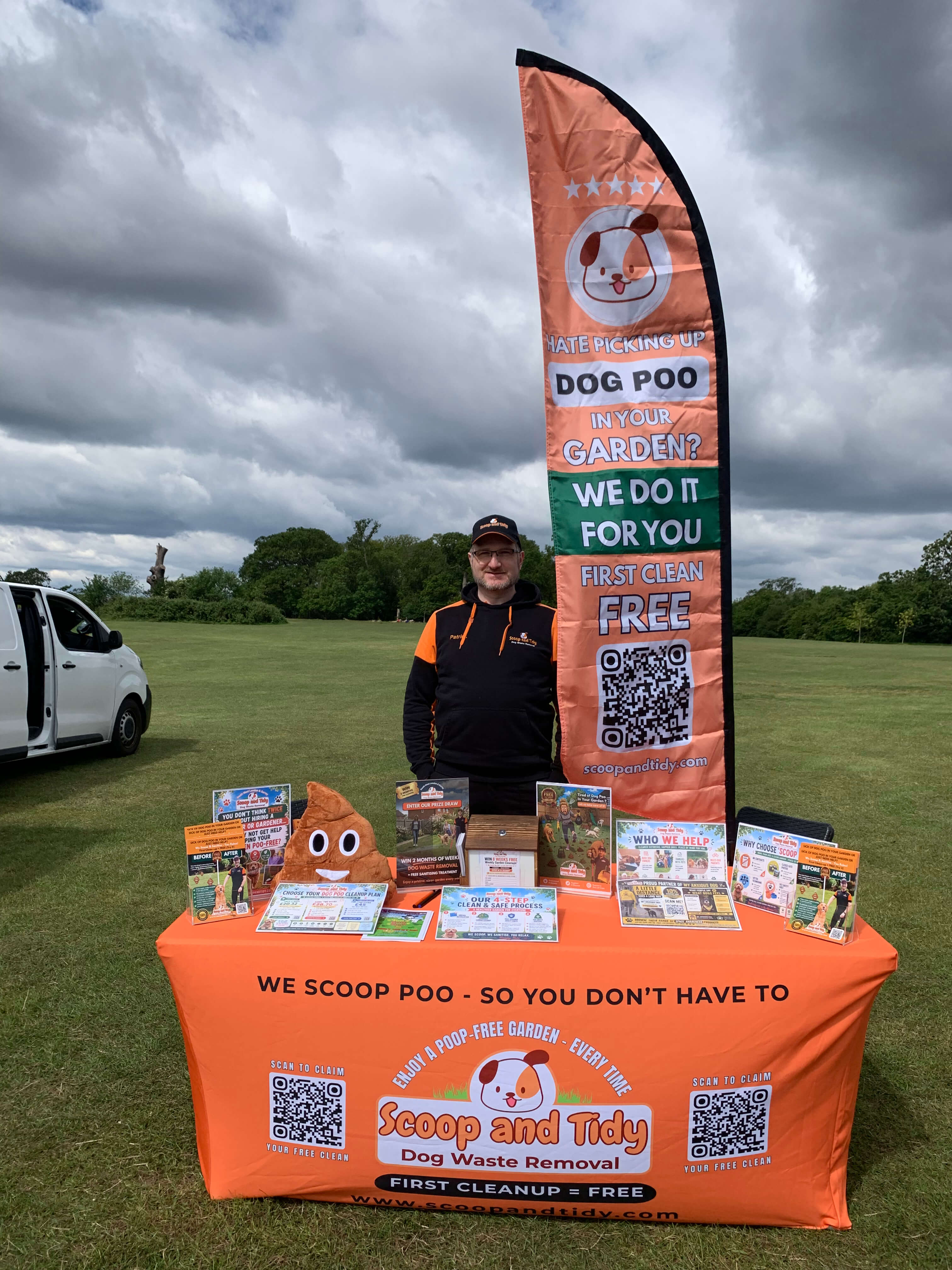 image of the owner of Scoop and Tidy standing at his booth at an outdoor event