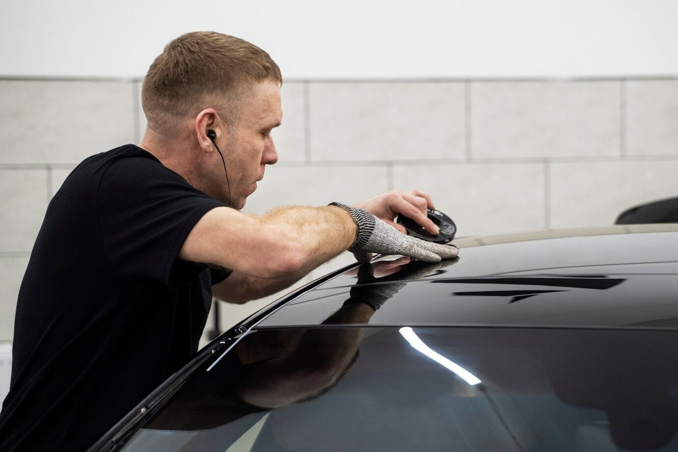 Installer applying custom vinyl wrap to a vehicle in Arizona
