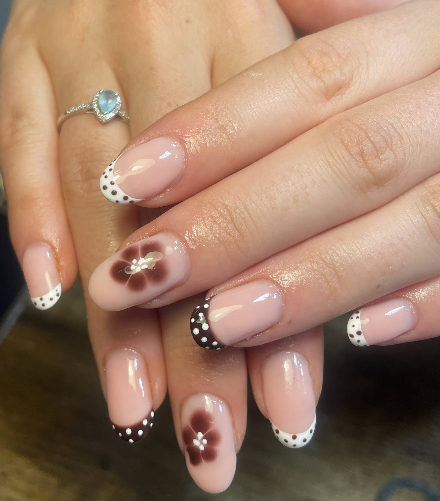 A precision manicure — neutral nails shaped with a sculptor's attention.