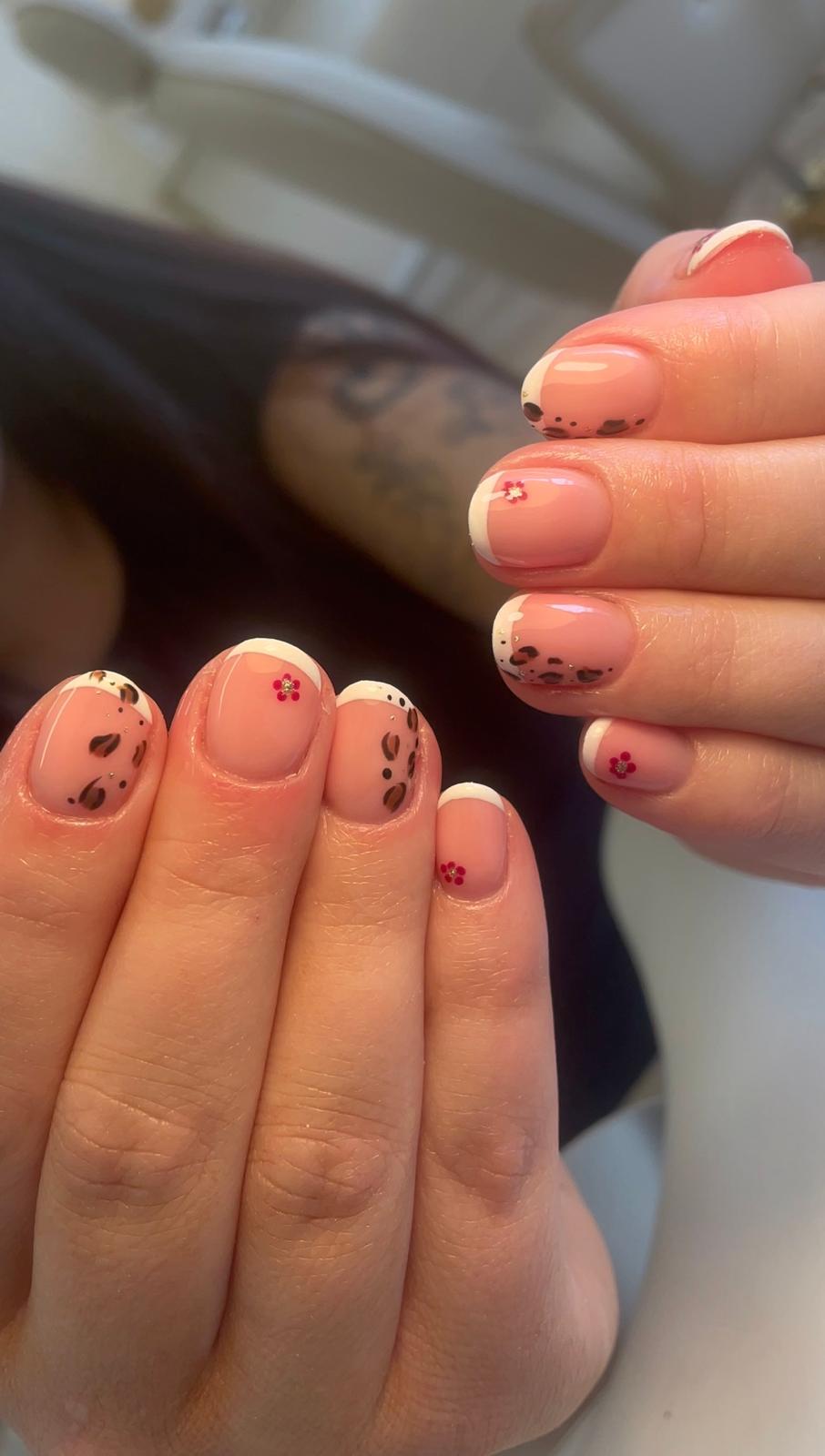 A precision manicure — neutral nails shaped with a sculptor's attention.
