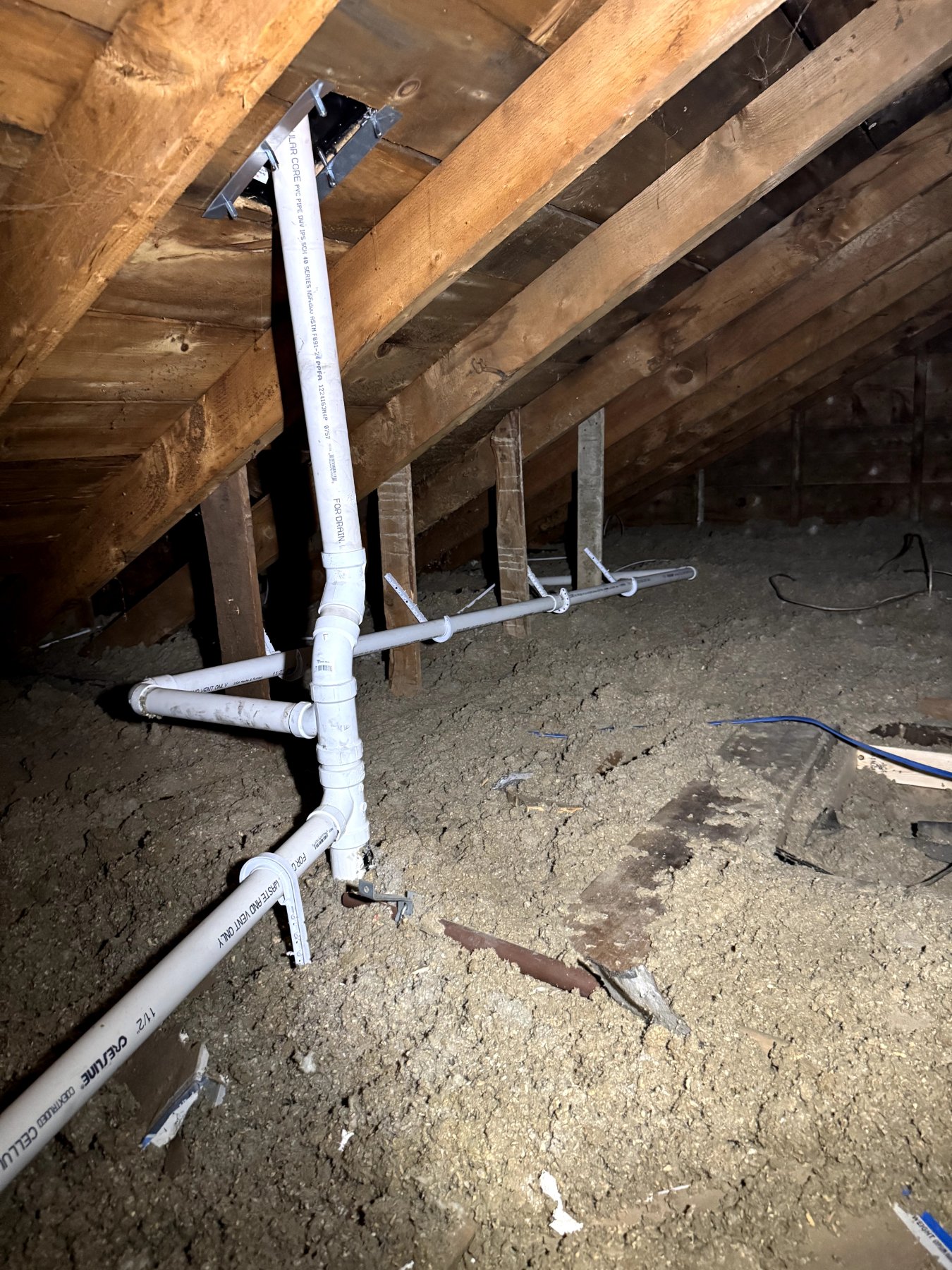New vent piping routed through an attic during a home remodel