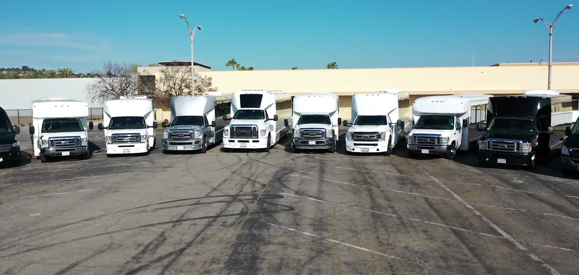 Angel Limo of Palm Springs party bus and limo fleet, including stretch limos, Sprinter vans, and party buses, parked in Palm Springs, CA