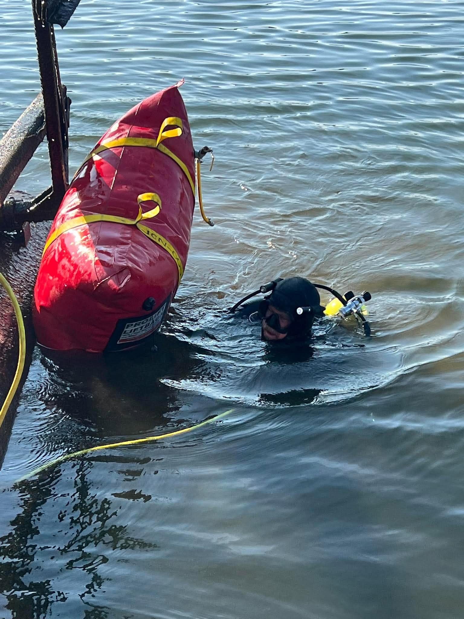 LOZ Dive commercial diver working beside a submerged boat