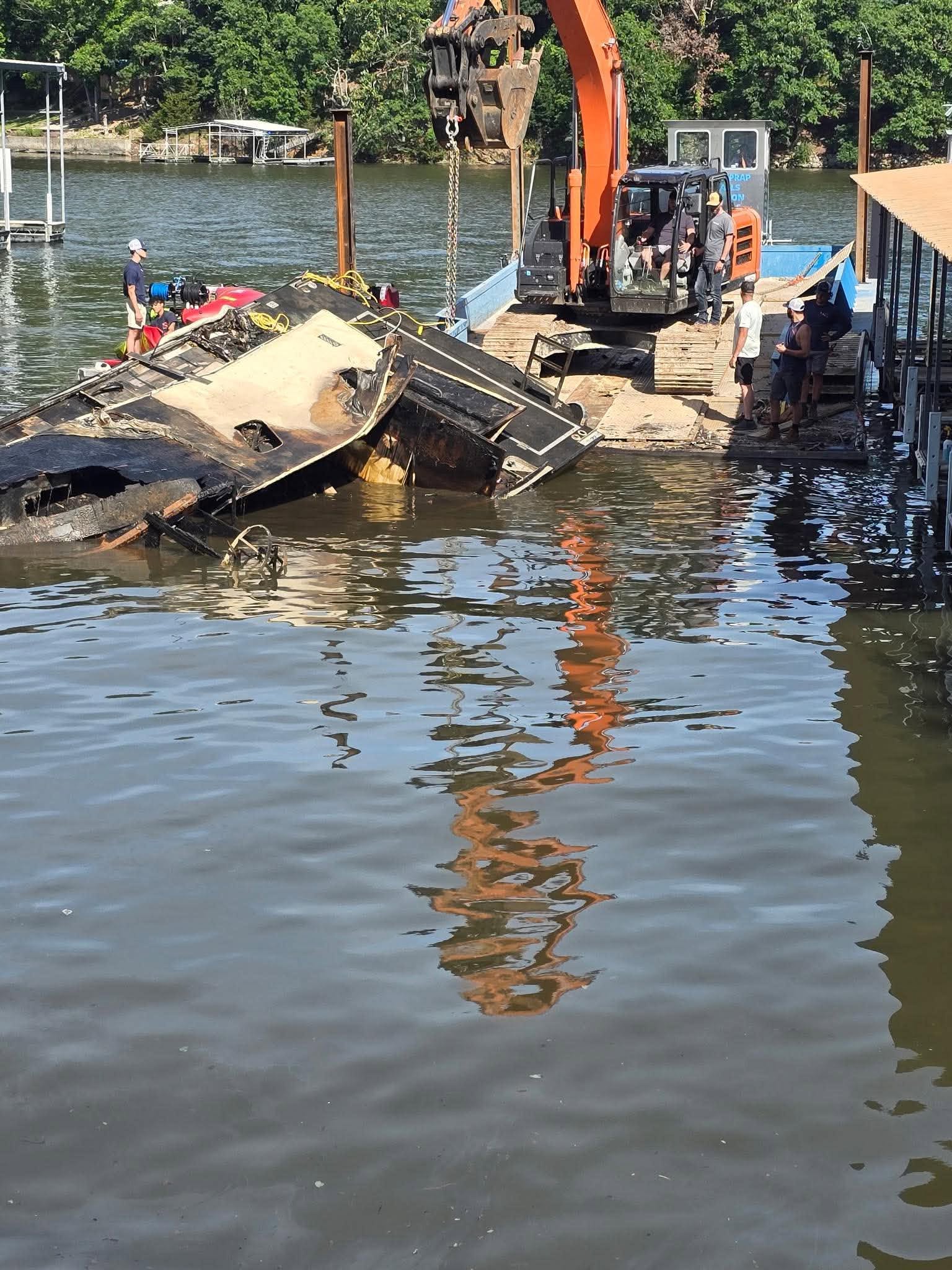 Partially submerged boat at a dock on Lake of the Ozarks