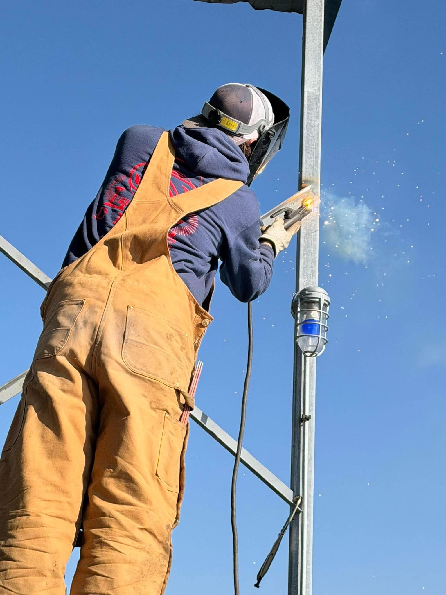 Welder repairing a steel dock frame at Lake of the Ozarks