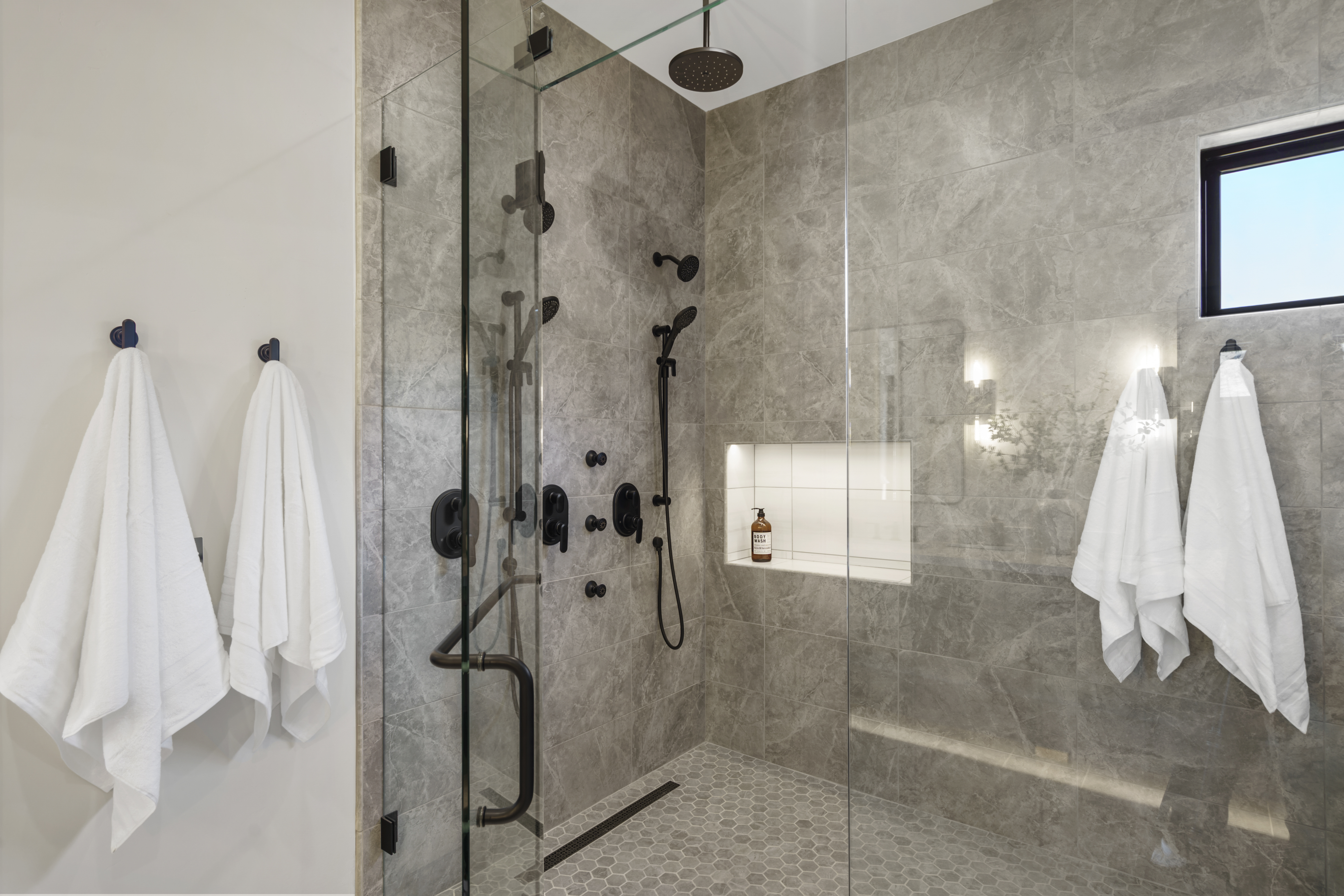 Primary bathroom walk-in shower with stone tile