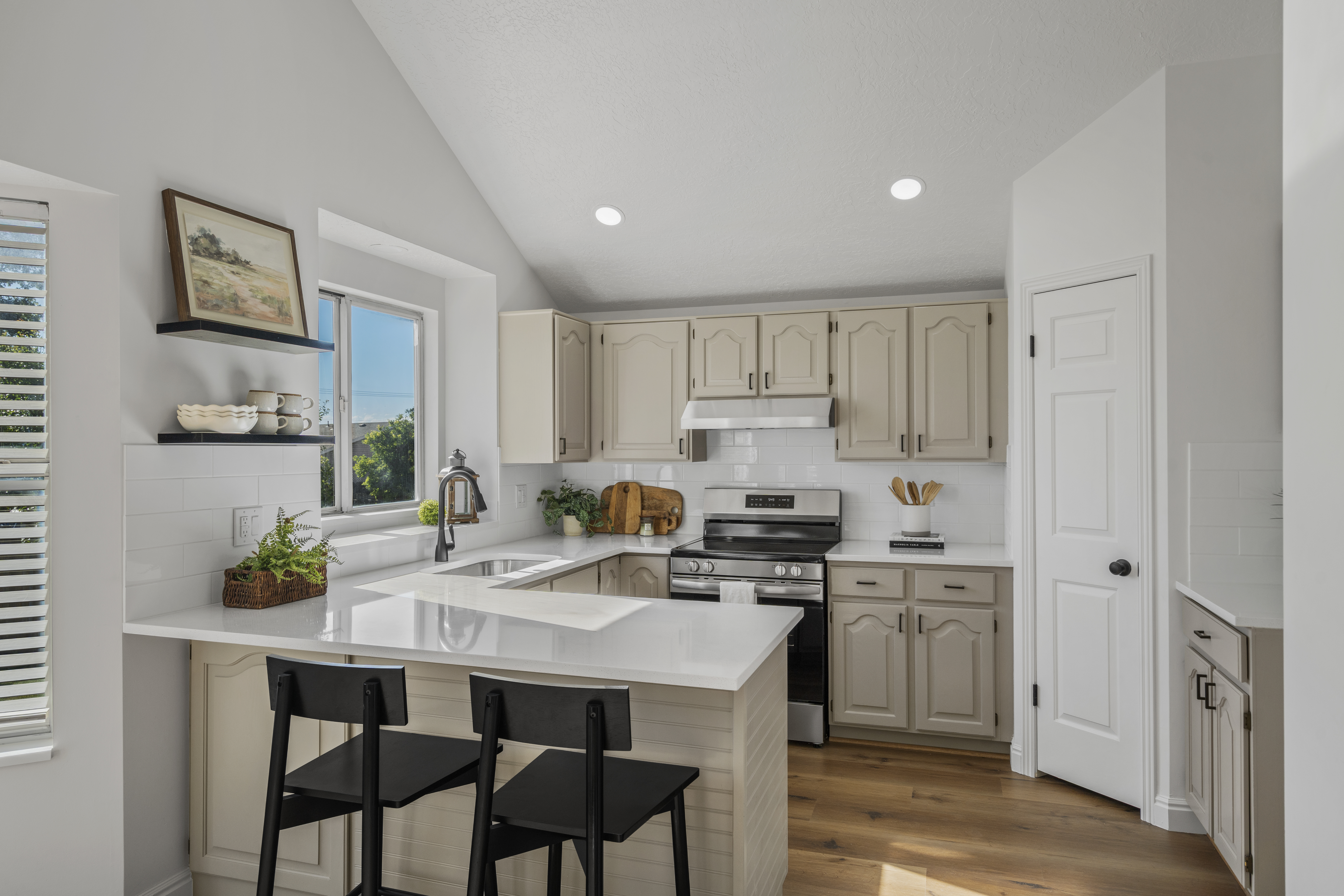 Bright kitchen with quartz counters and a breakfast bar
