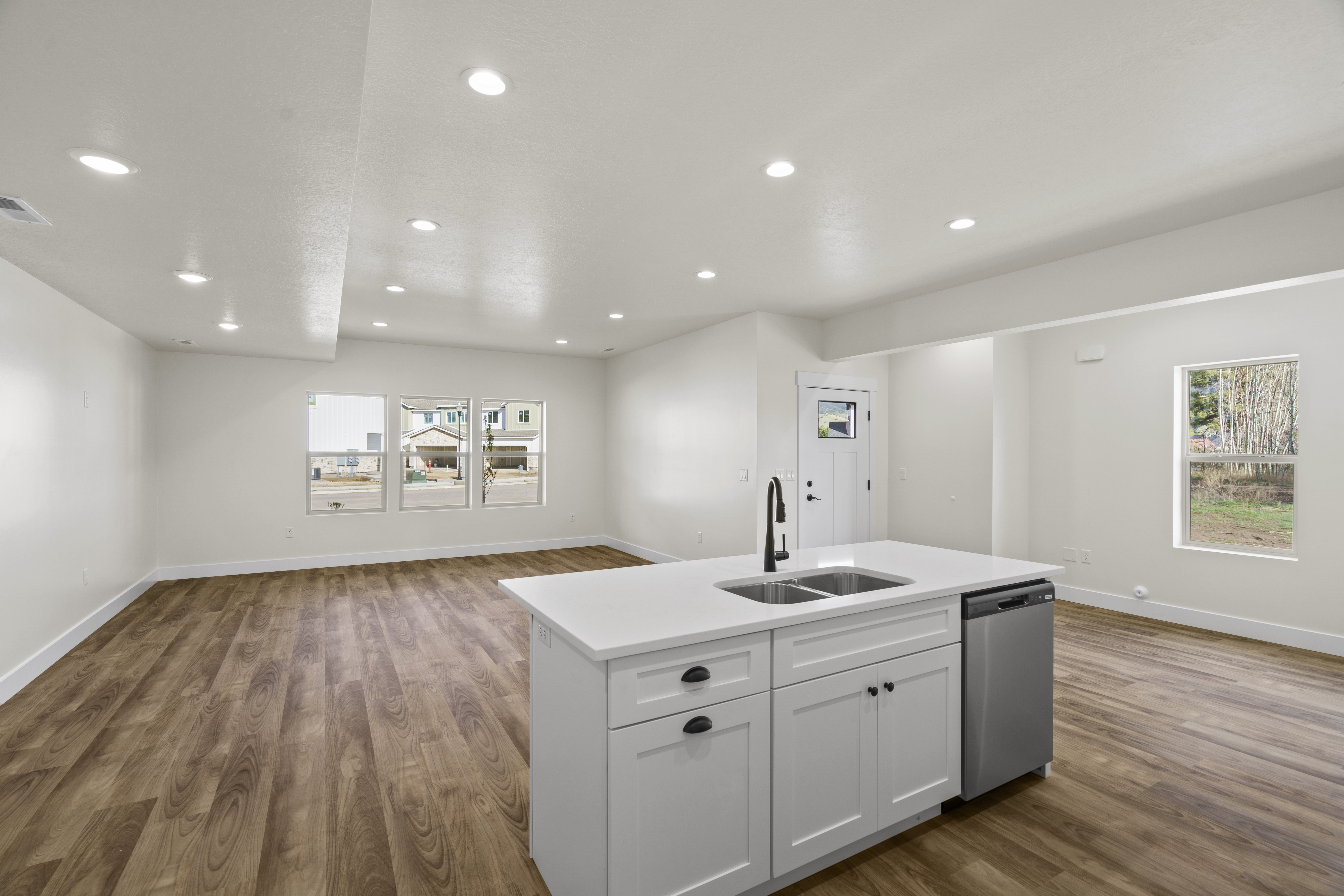 Open-concept white kitchen with a large island