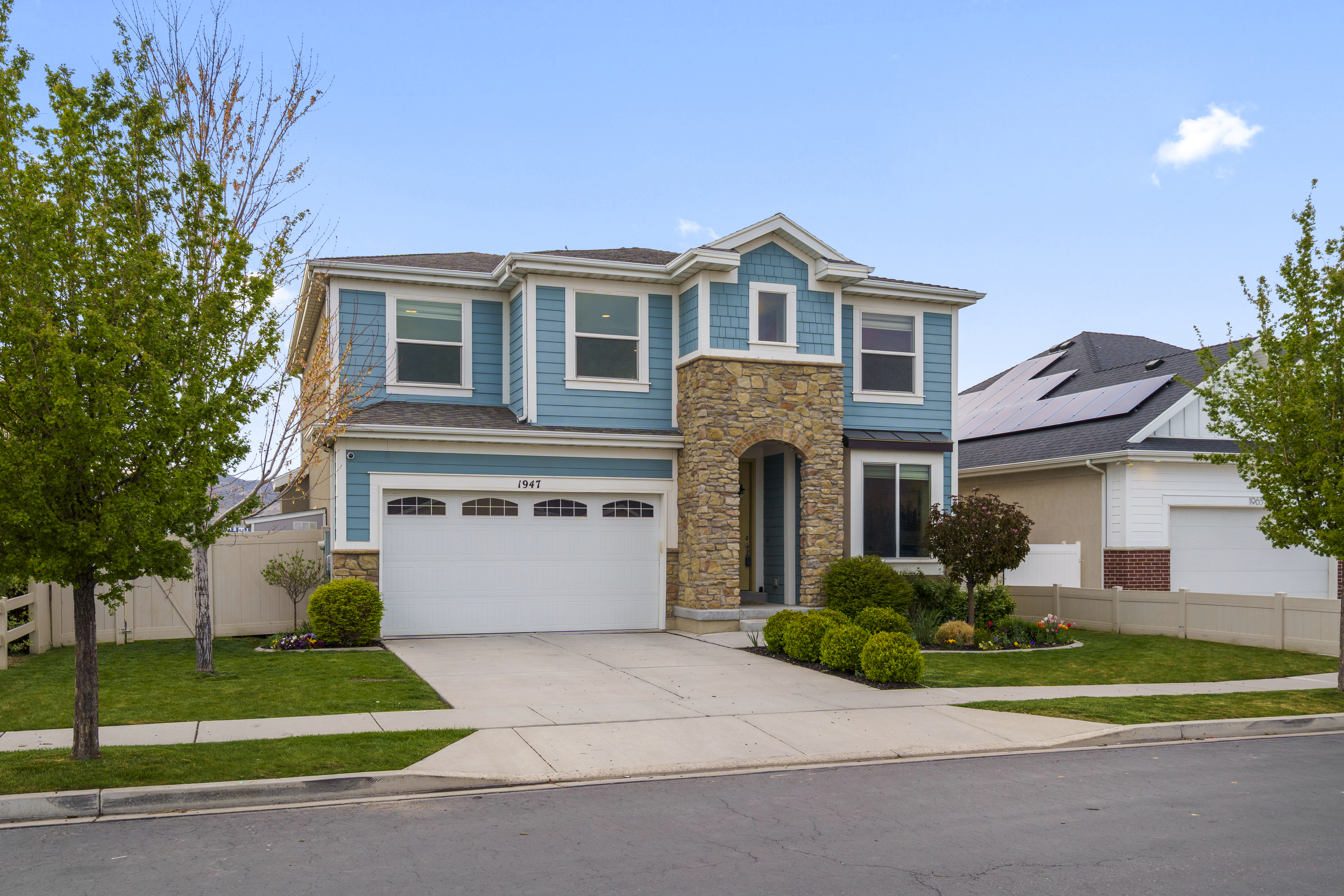 Front exterior of a two-story home with stone accents