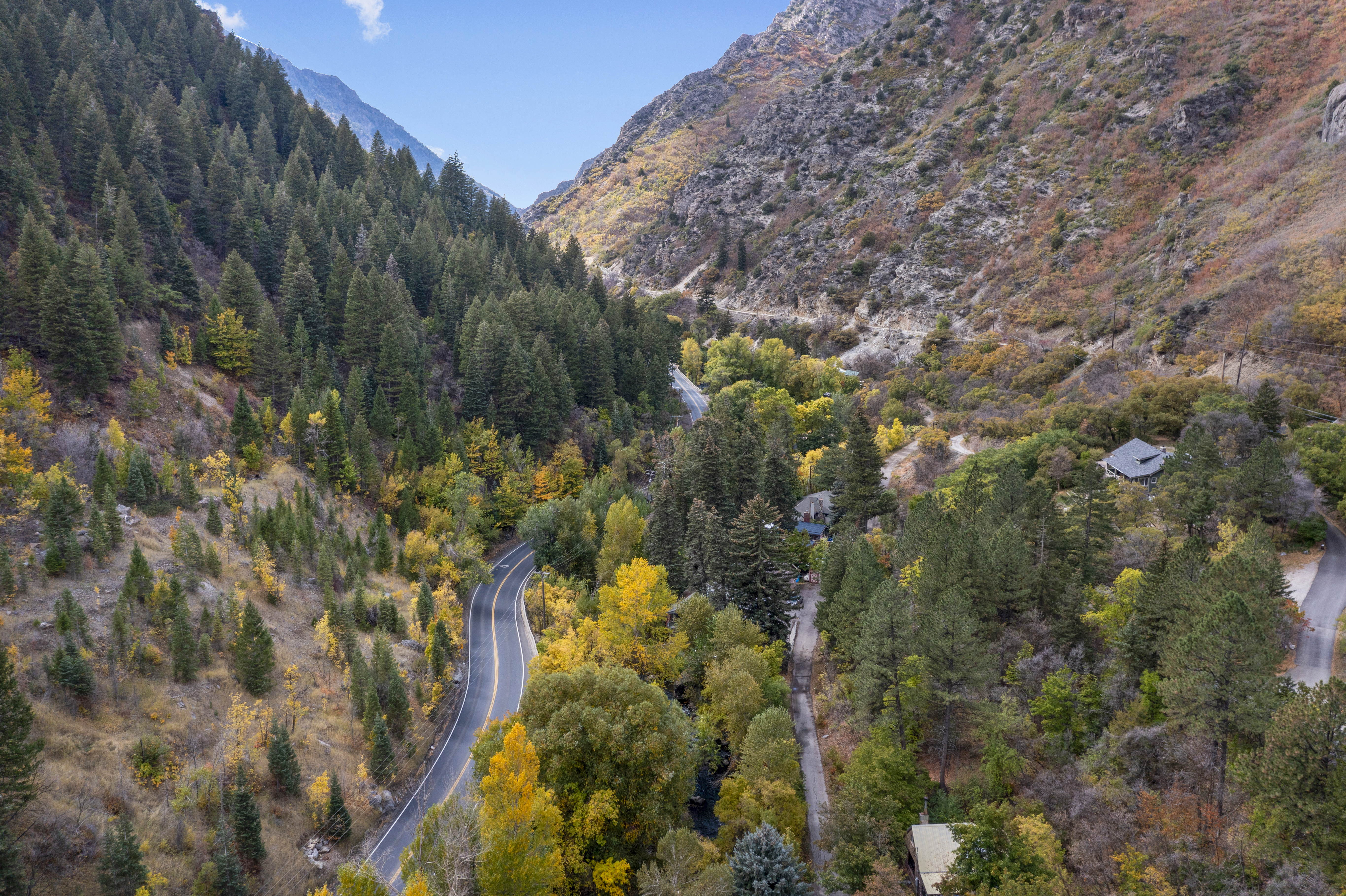 Aerial view of a mountain canyon road and surrounding property