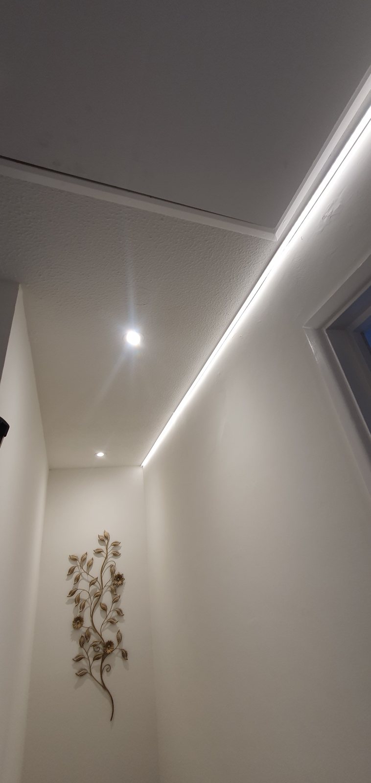 Concealed LED strip lighting in a coved ceiling recess