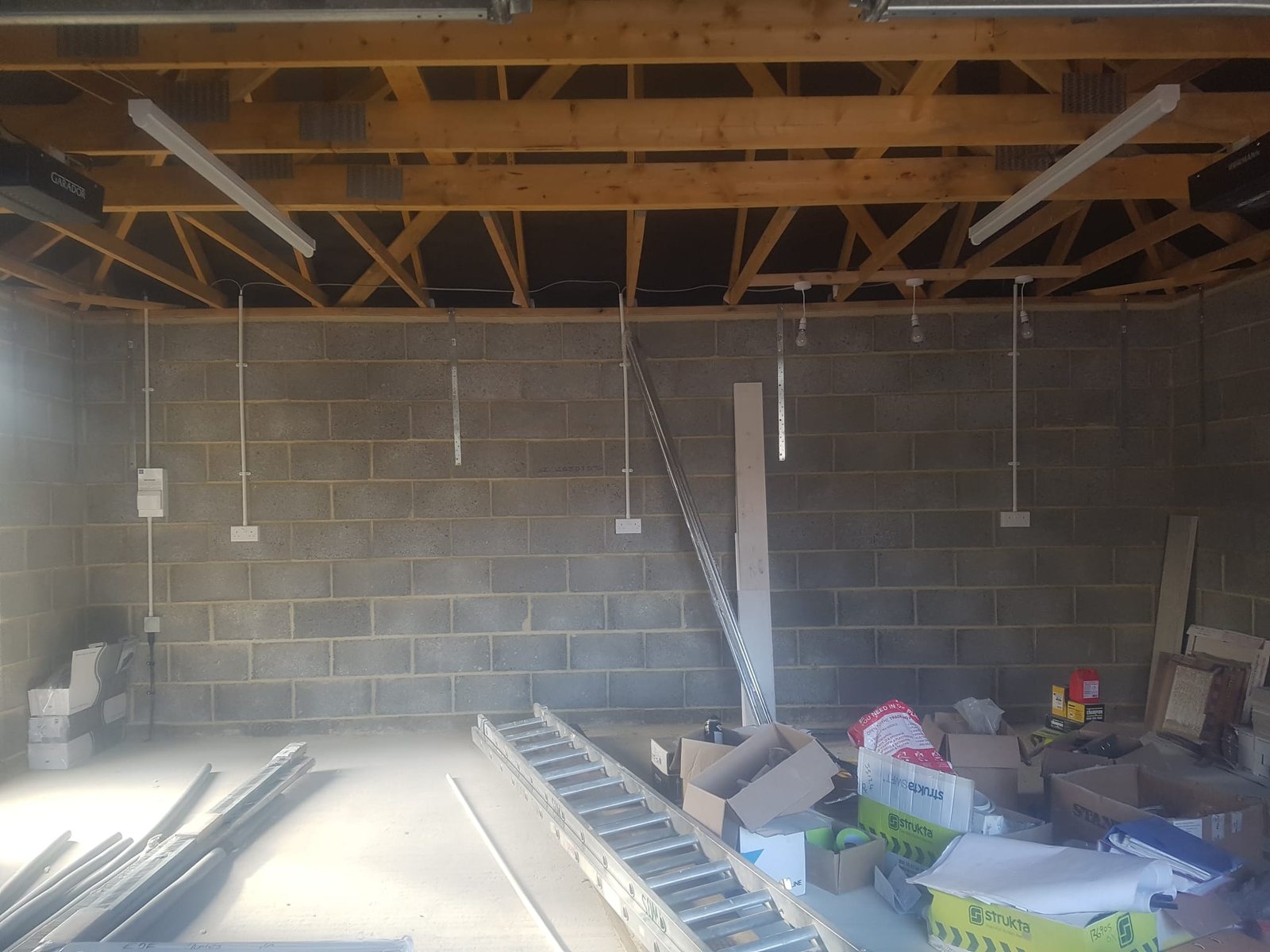 Suspended lighting installed in a commercial roof space by Cord Electrical