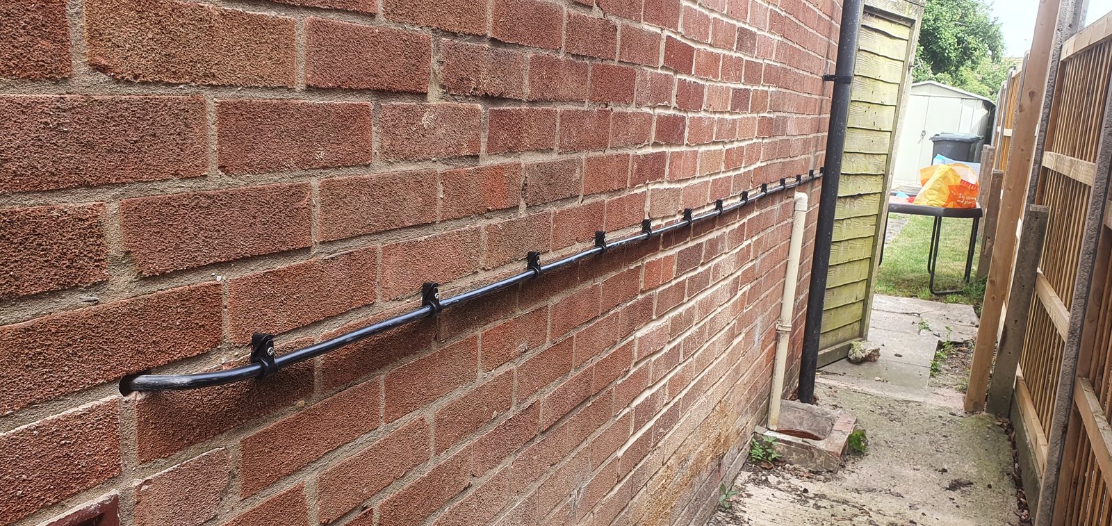Neatly cleated SWA cable running to a new point for a hot tub along a wall