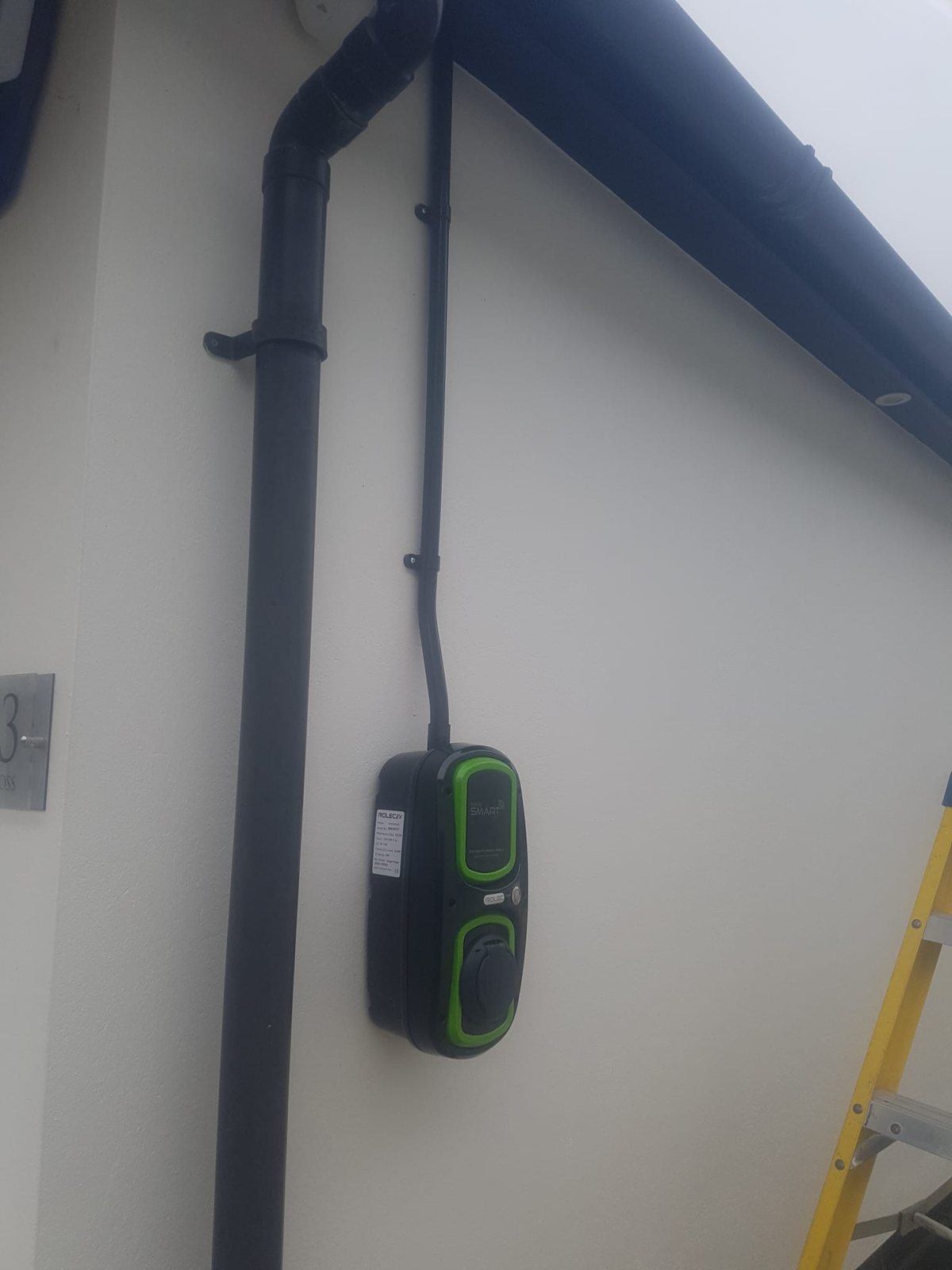 Electric vehicle charge point mounted on a wall with cable run