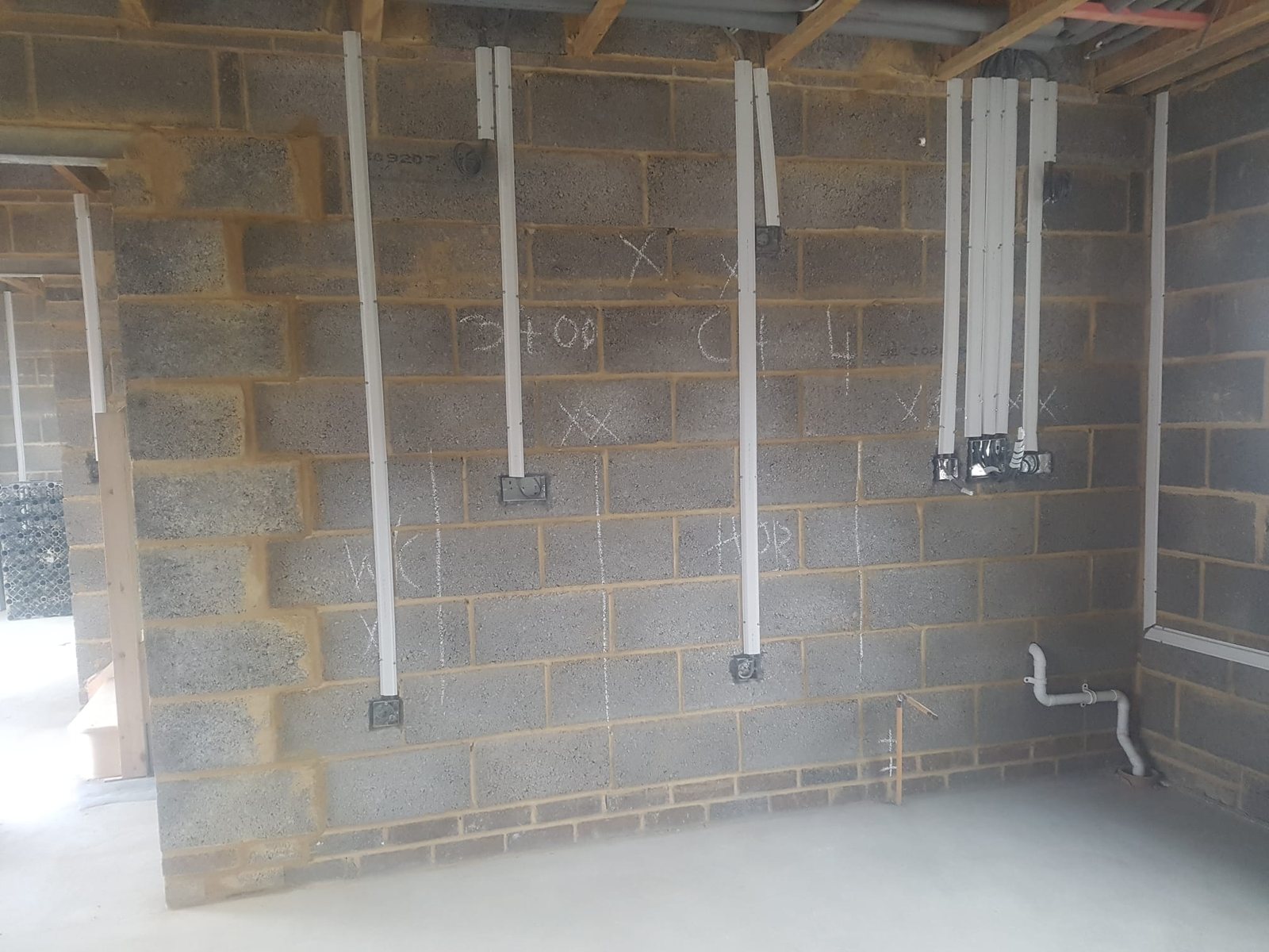 Surface conduit runs installed on blockwork walls by Cord Electrical