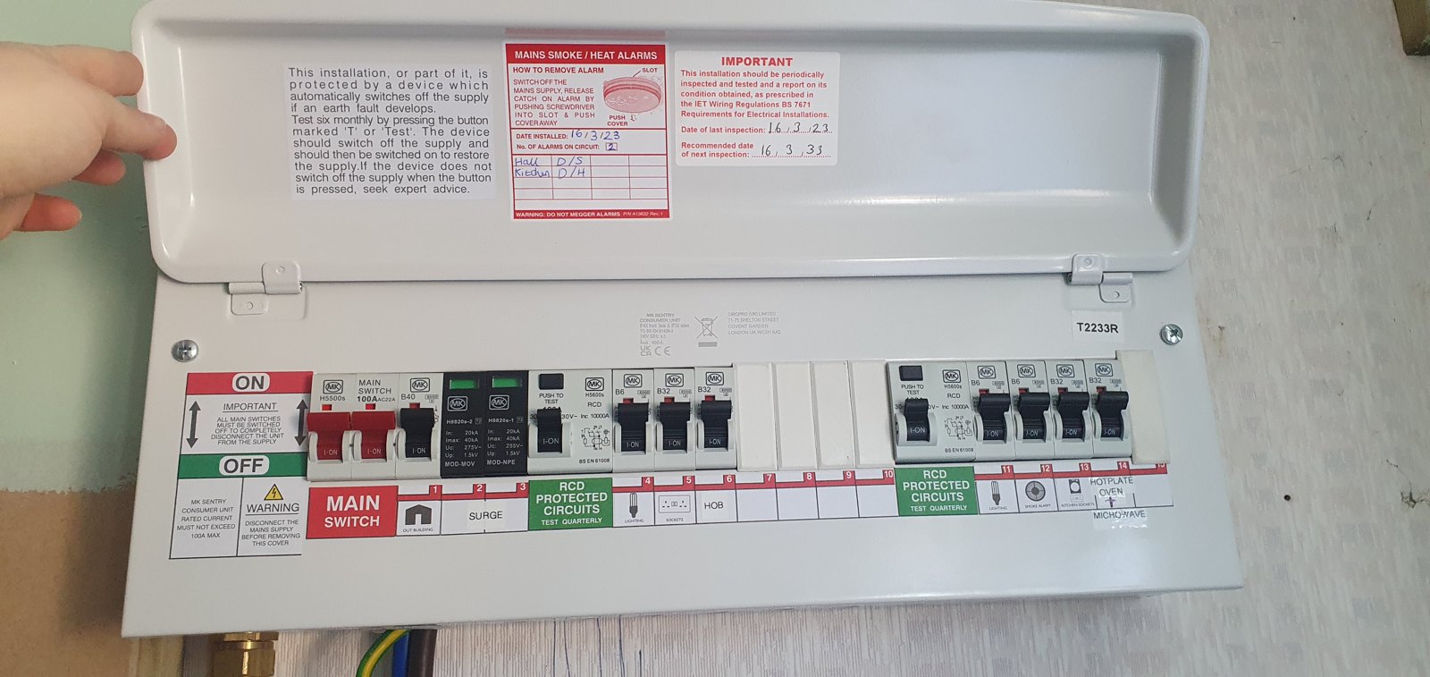 Open consumer unit showing labelled breakers and RCDs