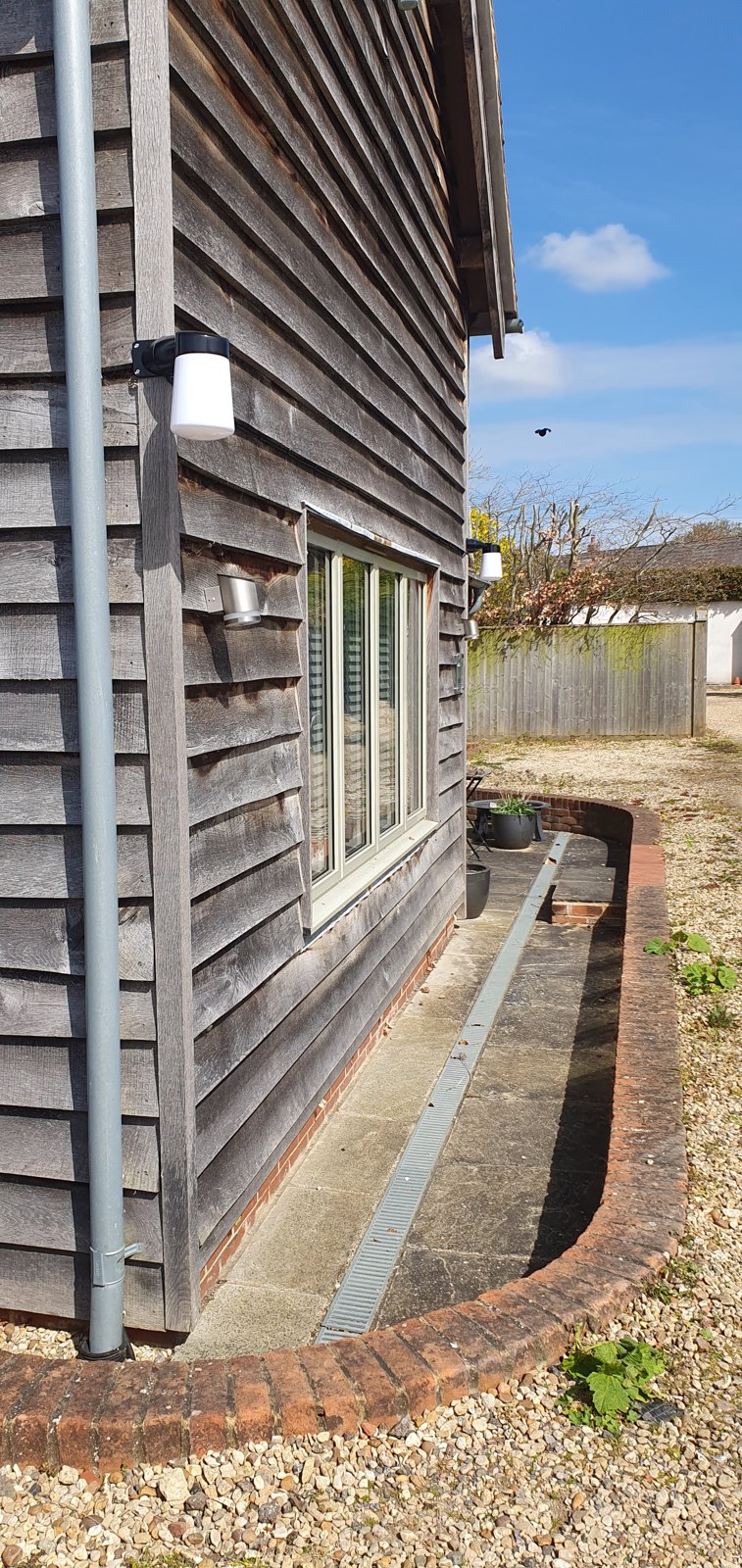 Exterior wall light fitted to timber cladding