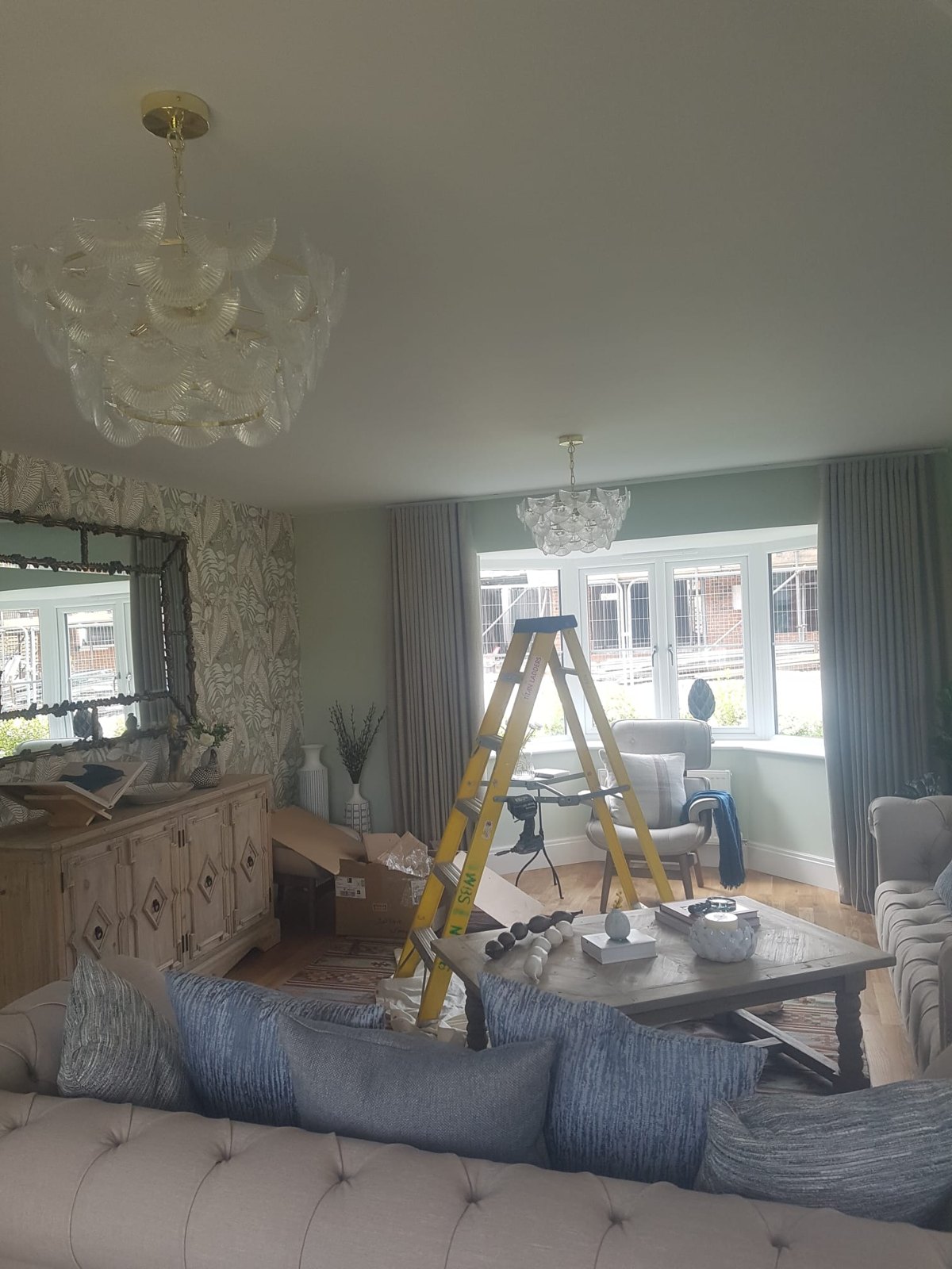 Glass chandelier installed in a living room ceiling
