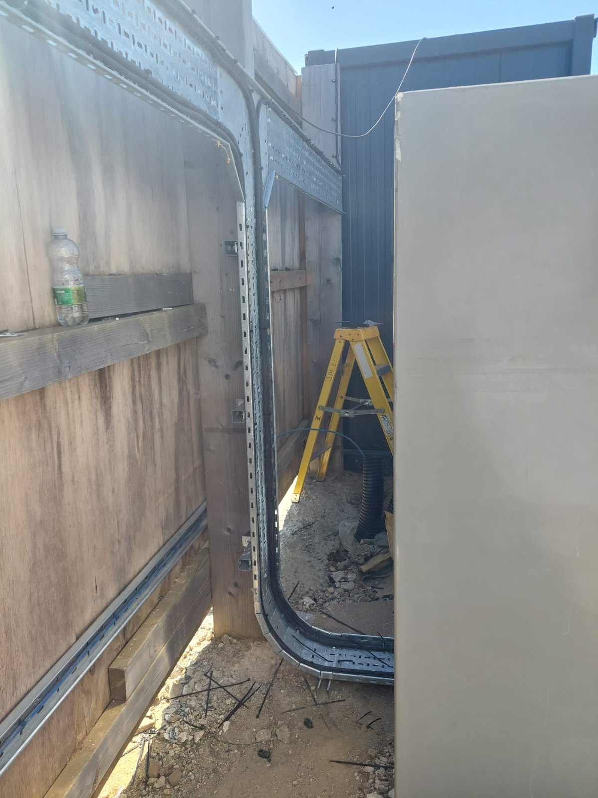 Ducting laid in a trench alongside a building