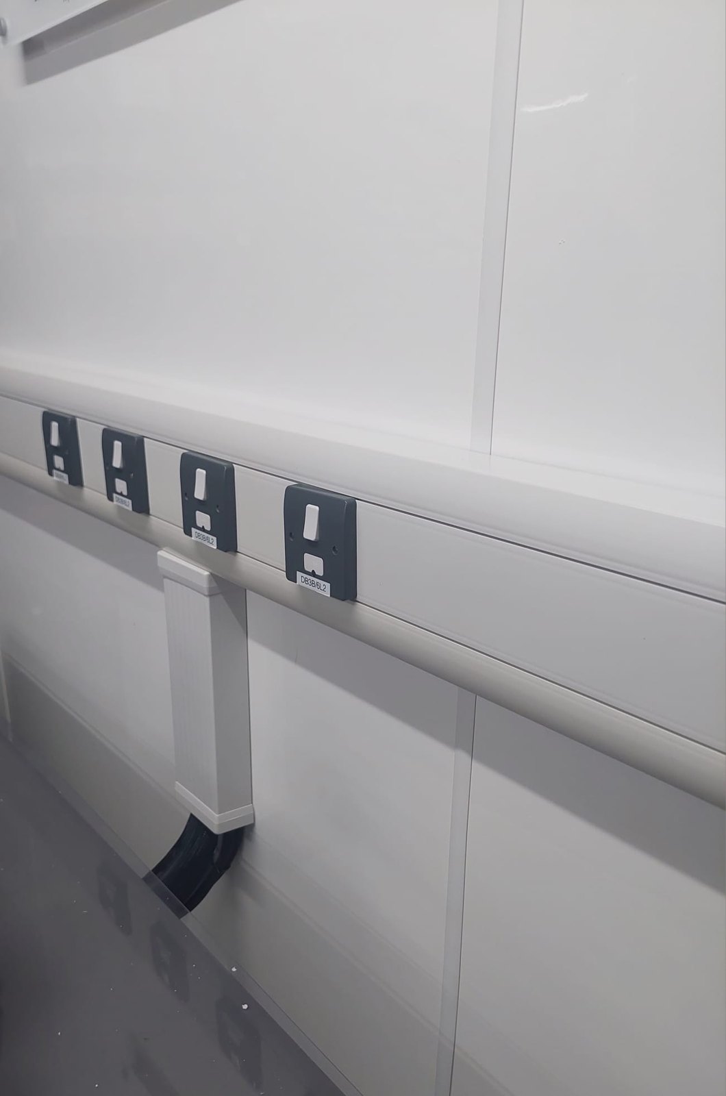 Row of outlets installed in office dado trunking