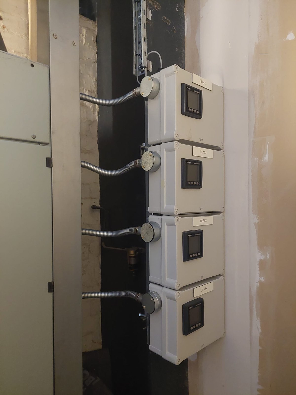 Four control enclosures mounted with conduit between them