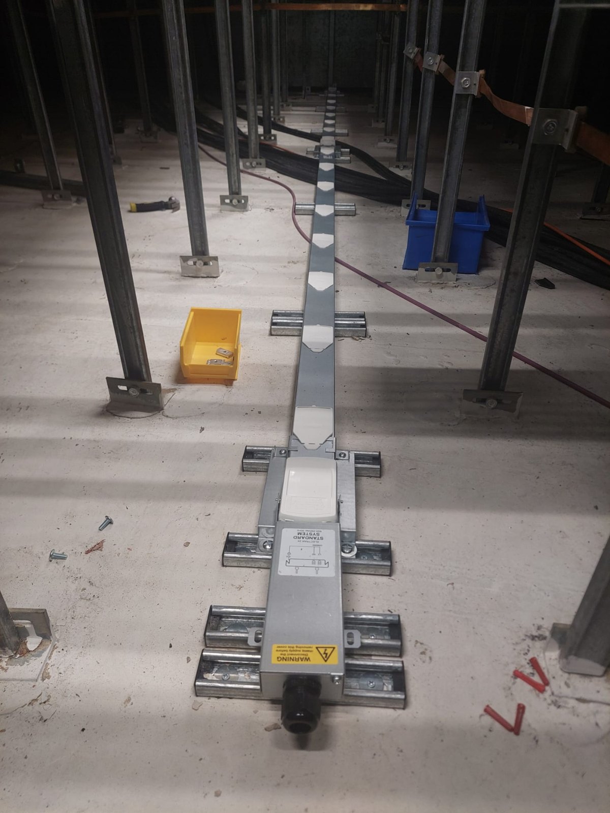 Containment run through a steel framed commercial building