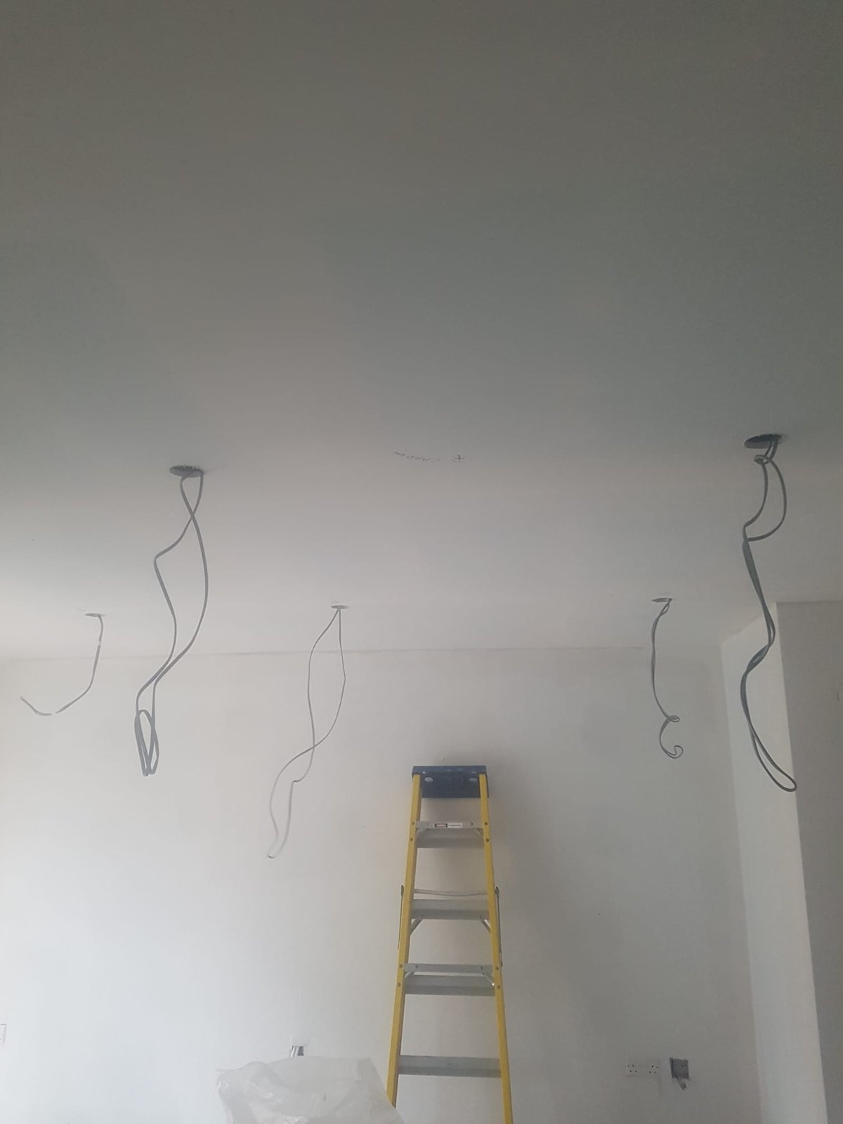 Lighting pendant drops wired into a newly plastered wall