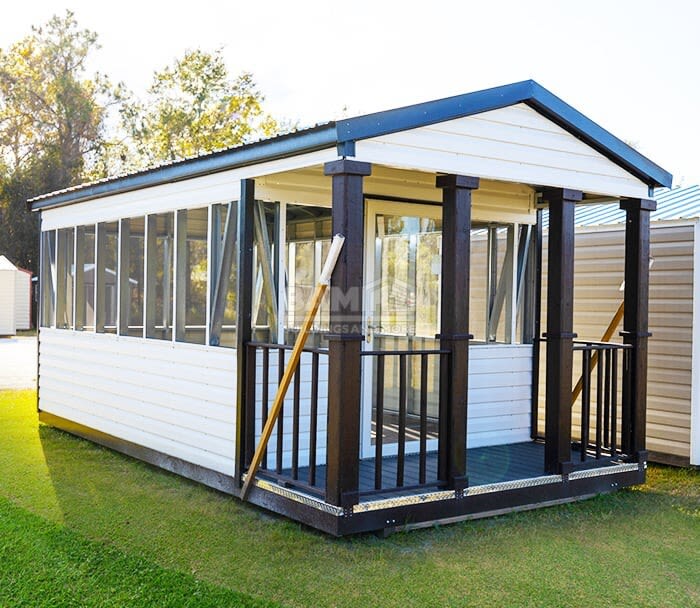 Portable building with a covered front porch and glass storm door