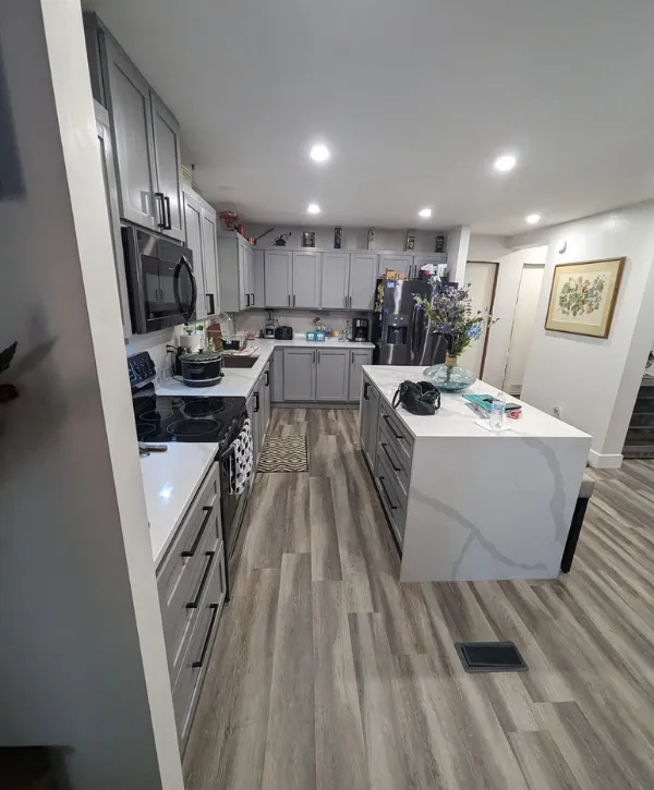A modern kitchen with gray cabinets and sleek countertops, creating a stylish and contemporary cooking space.