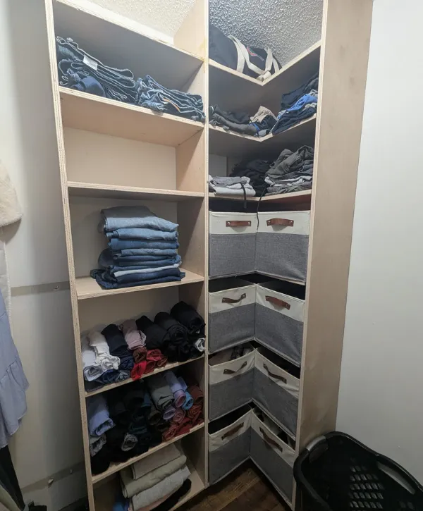  A custom walk-in closet with organized shelves and sections for hanging clothes, designed for maximum storage.