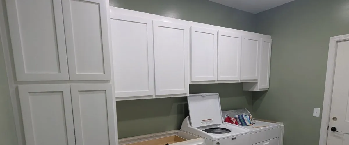  Laundry room with white custom cabinetry over washer and dryer