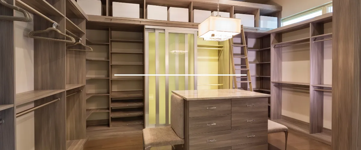 Luxury walk-in closet with custom shelving, center island drawers, and overhead storage space