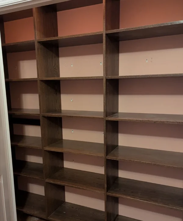 Custom wood closet shelving system with multiple storage compartments.