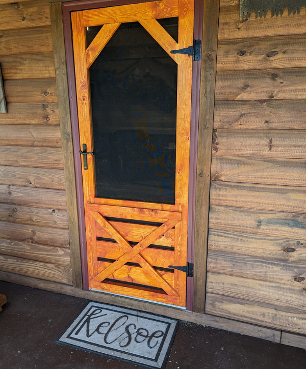 Custom wood screen door with decorative cross-brace design
