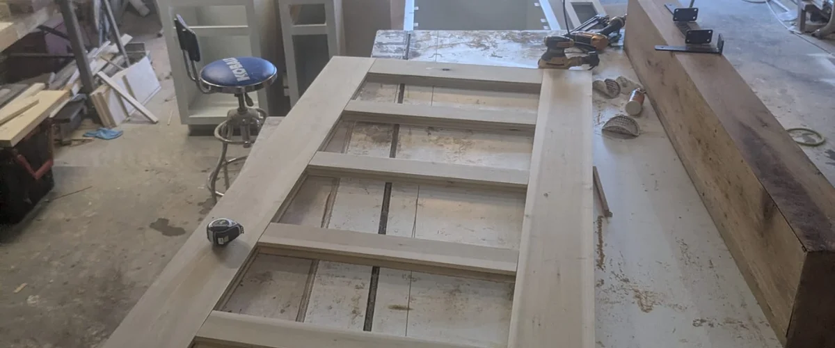 Custom wood door frame being built in woodworking shop