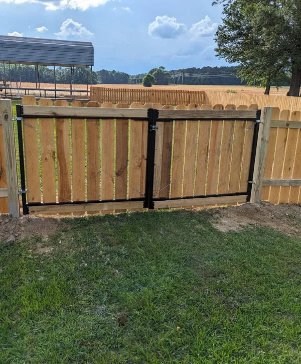 Double wooden fence gate with metal frame and hardware