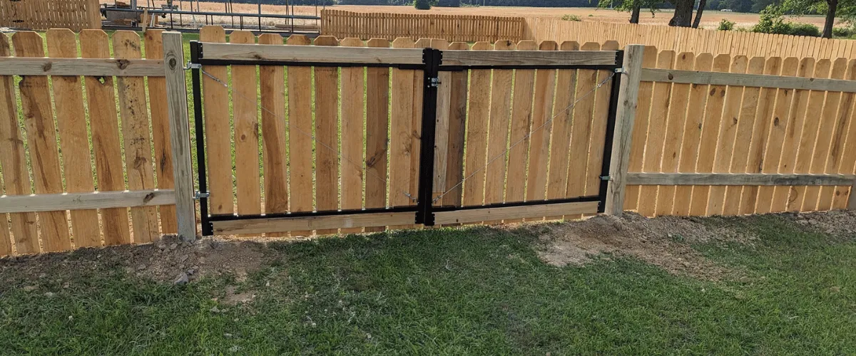 Wooden double gate integrated into privacy fence