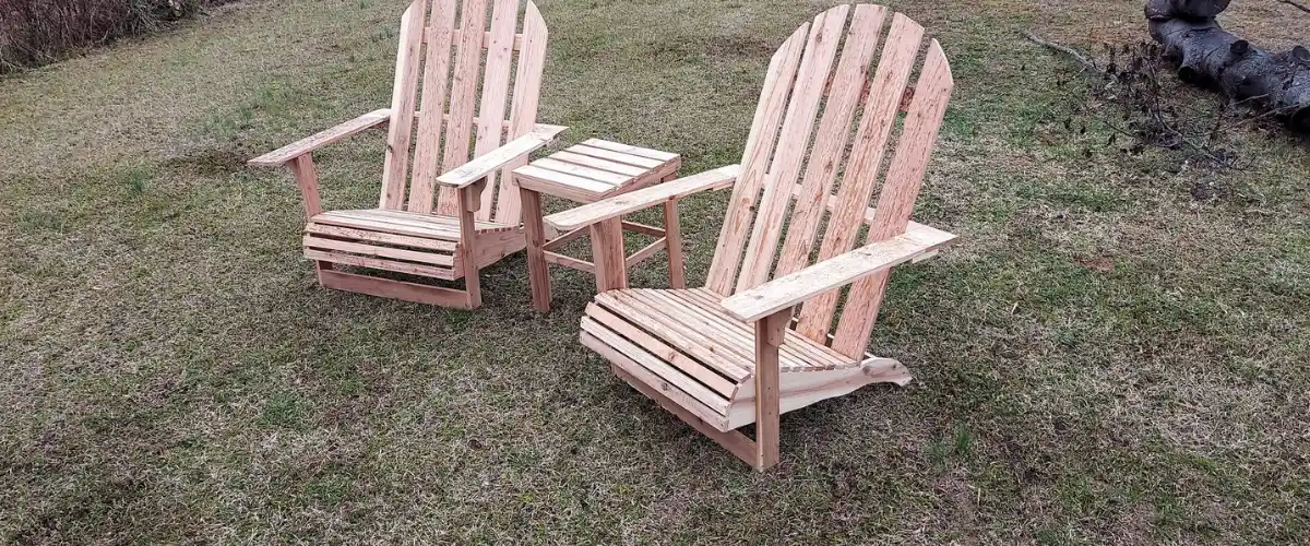 Handcrafted wooden Adirondack chairs with small outdoor table