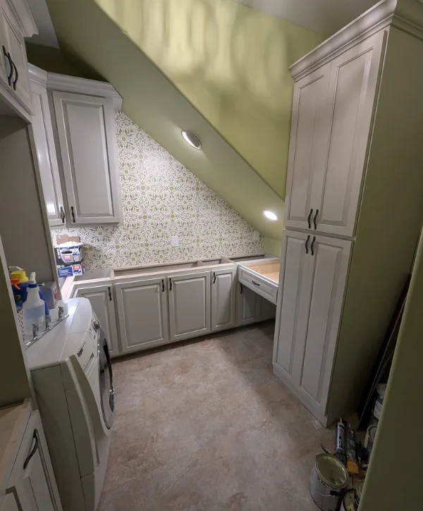 Custom laundry room cabinets with built in storage and washing machine space