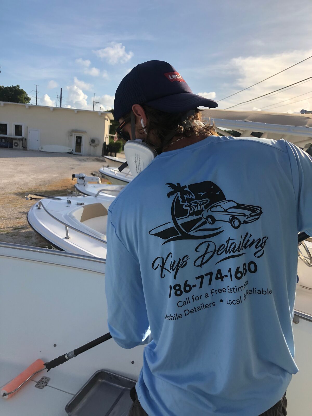 Keys Detailing mobile detailer in a branded shirt detailing a boat