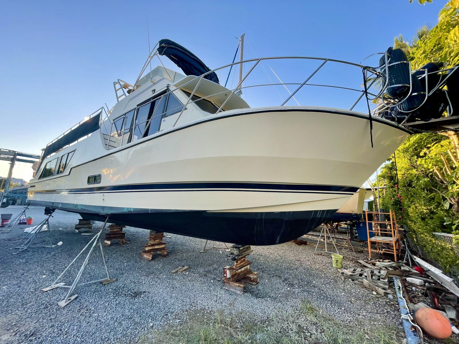 Large motor yacht with polished cream hull detailed in a Florida Keys boat yard