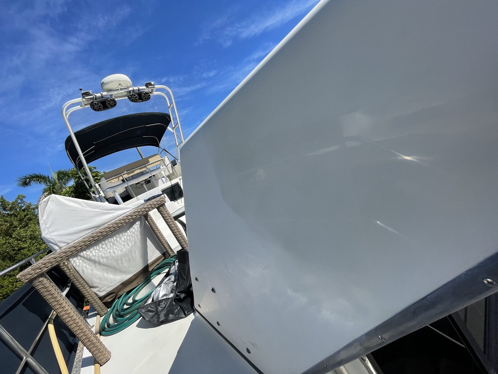 Deep gloss gel coat finish on a boat panel after machine polish