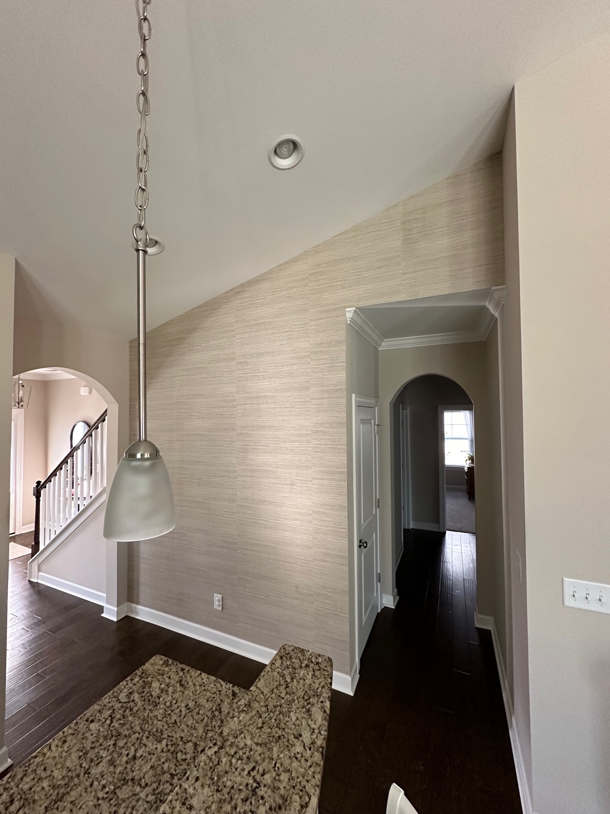 Grasscloth accent wall in a luxury home entryway