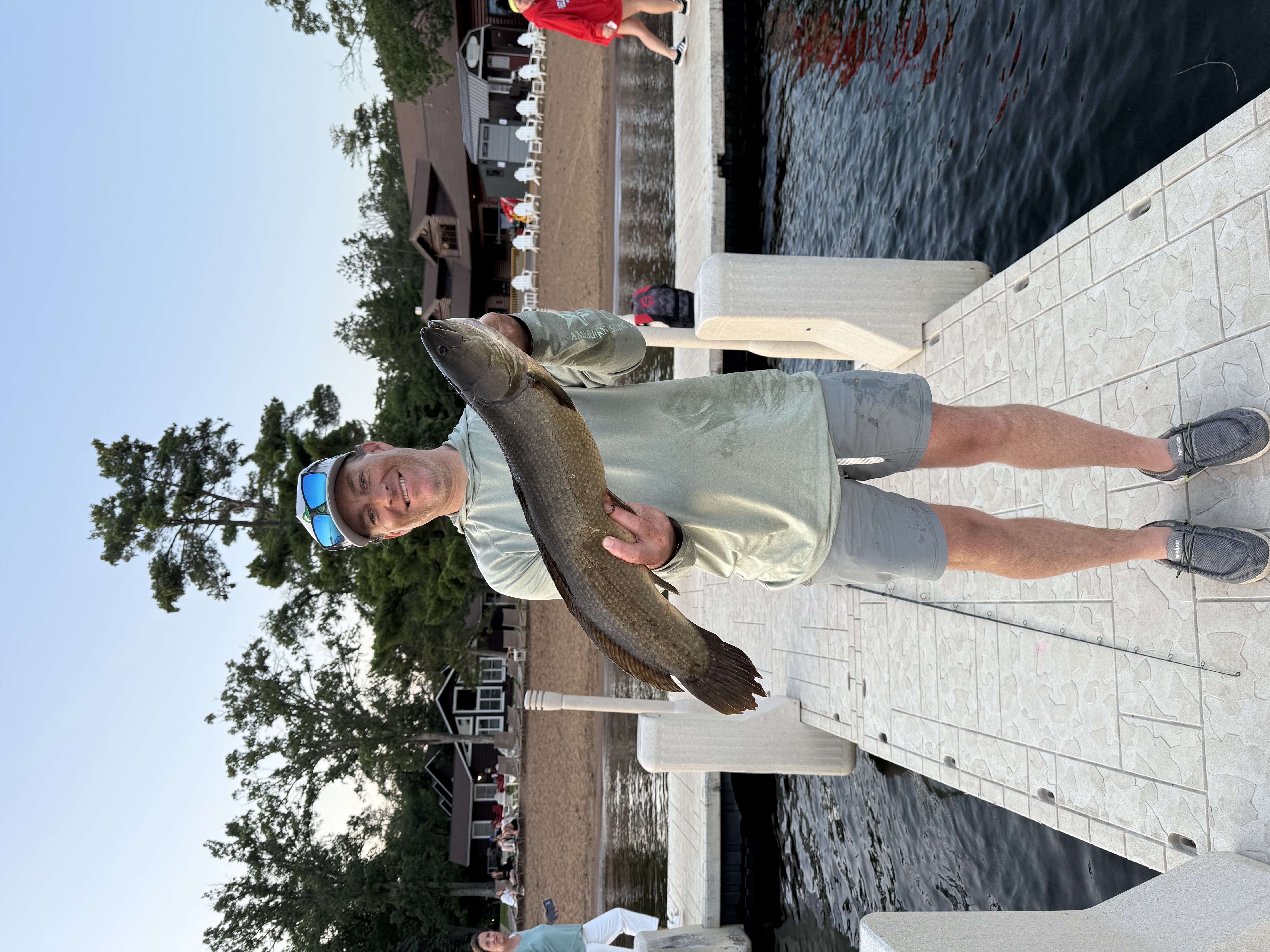 Captain Jamison Johnson holding a sturgeon on the St. Croix River