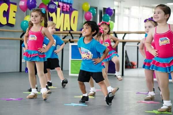 Group of 6-8 year old students enjoying a Ready Set Dance class at Pazaz Dance Company, catering to various dance styles and ability levels.