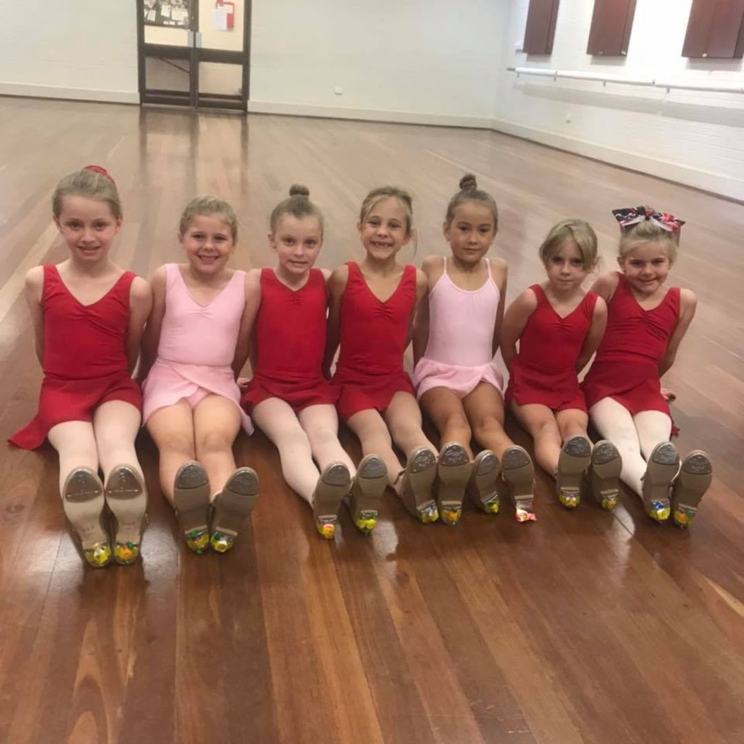 Students enjoying the company of friends, smiling and holding each other. Join our inclusive dance community in Belmont and Baldivis. Explore diverse dance programs today!