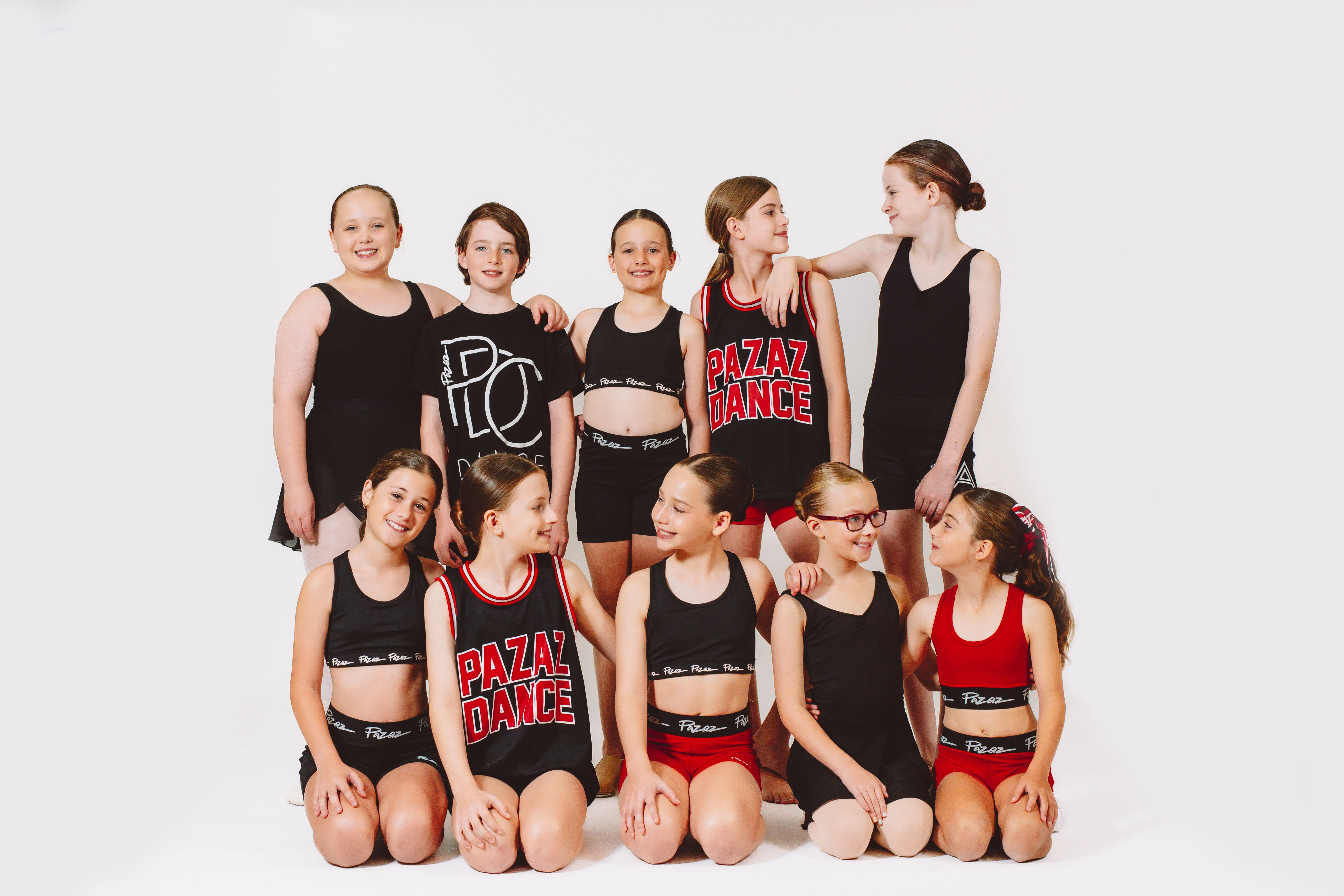 Students from Pazaz Dance Company eagerly preparing to perform at the mid-year showcase, showcasing enthusiasm and readiness for their dance routine.