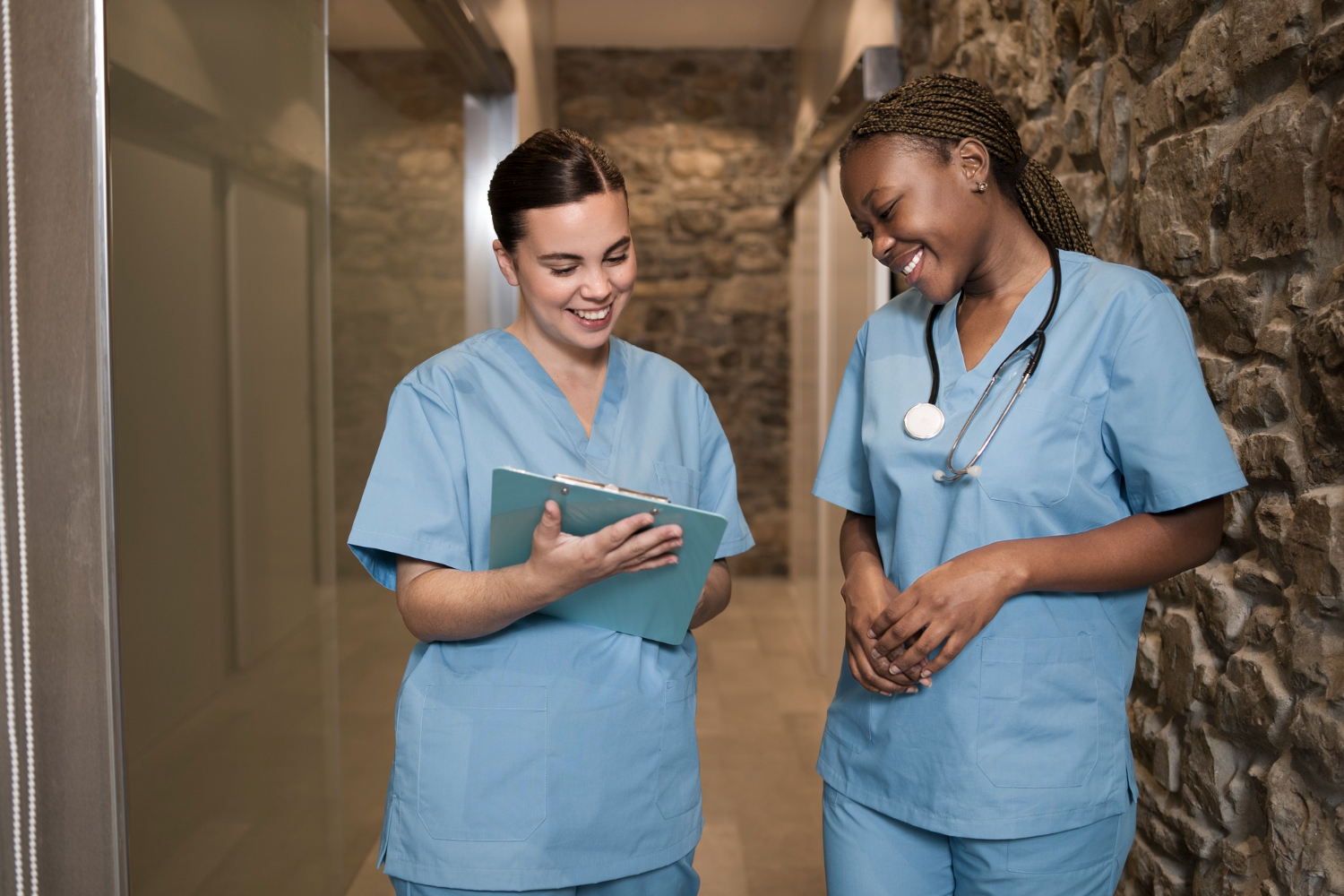 Portrait of two female nurses at the clinic with male doctor