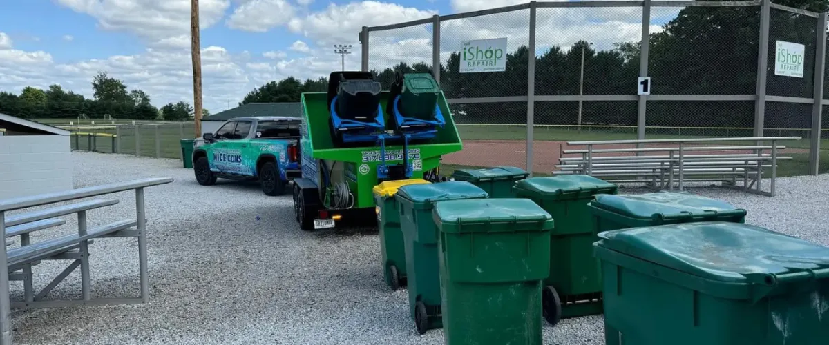 Trash bin cleaning service equipment on site with bins